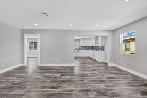 the living room and kitchen in a new home
