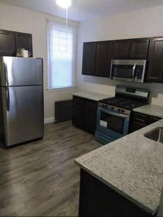 a kitchen with stainless steel appliances and a refrigerator