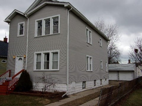 a gray house with white siding and white windows