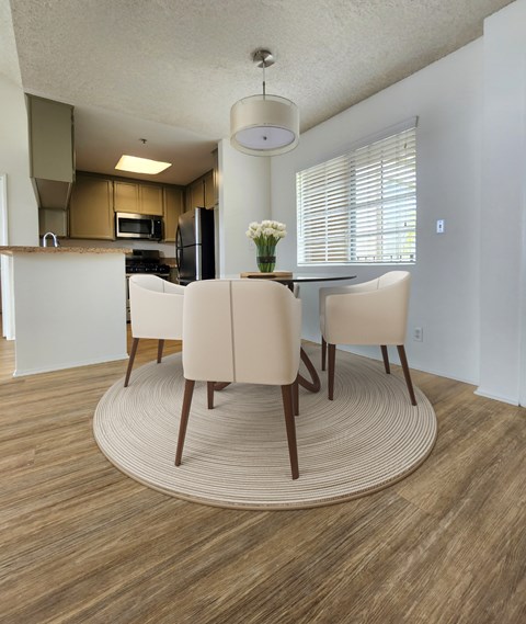 A dining room with a table and chairs.
