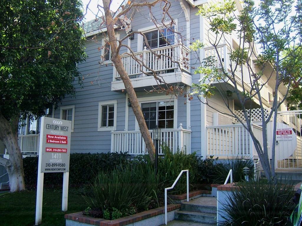 a white house with a sign in front of it