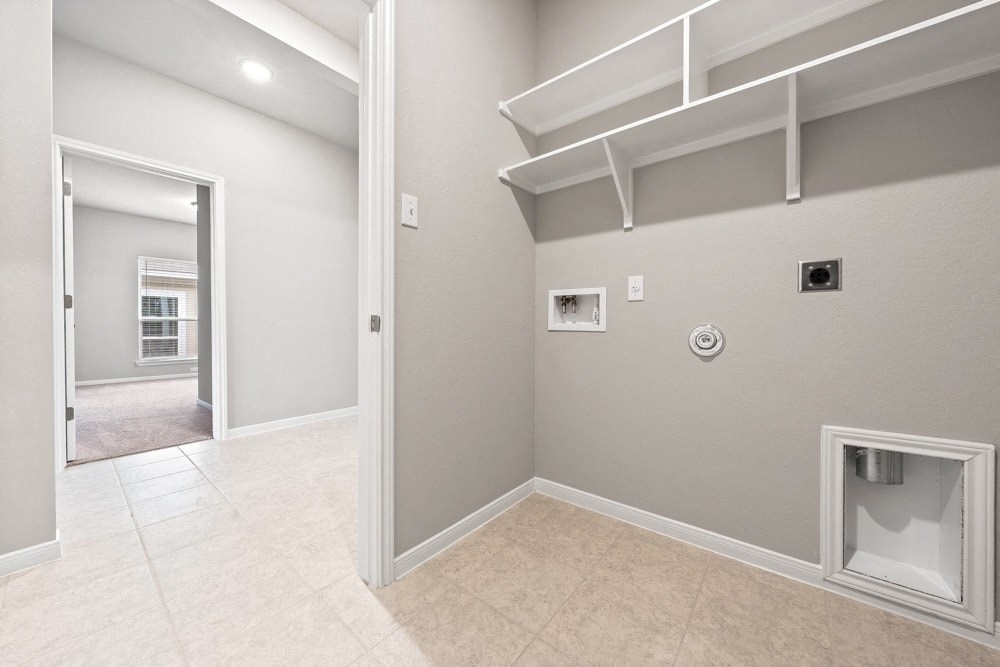 the spacious living room and laundry room in a new home