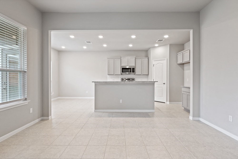 an empty kitchen with a counter in the middle of it