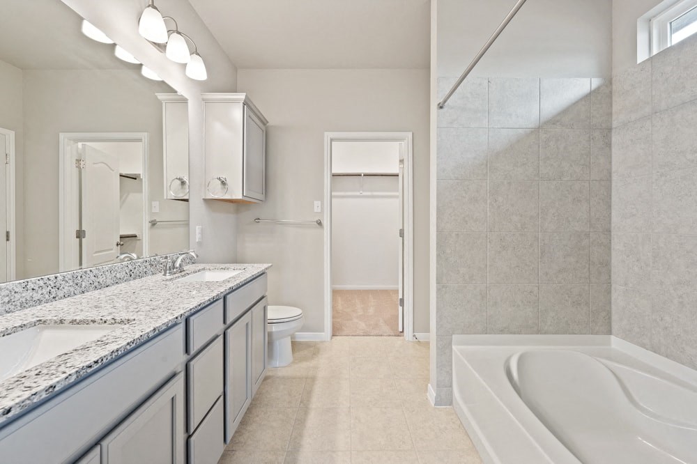 a bathroom with a tub and a sink and a shower