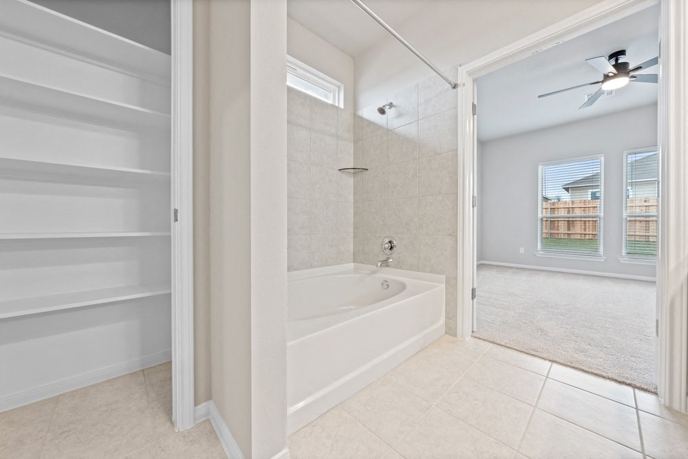 a bathroom with a tub and a shower and a closet