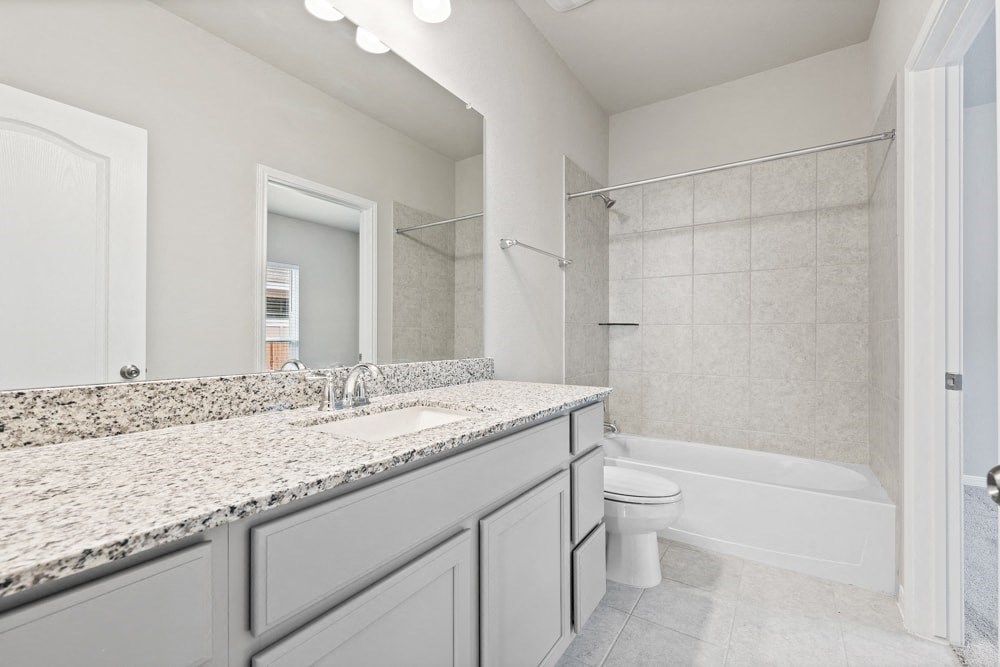 a bathroom with a sink and a toilet and a shower