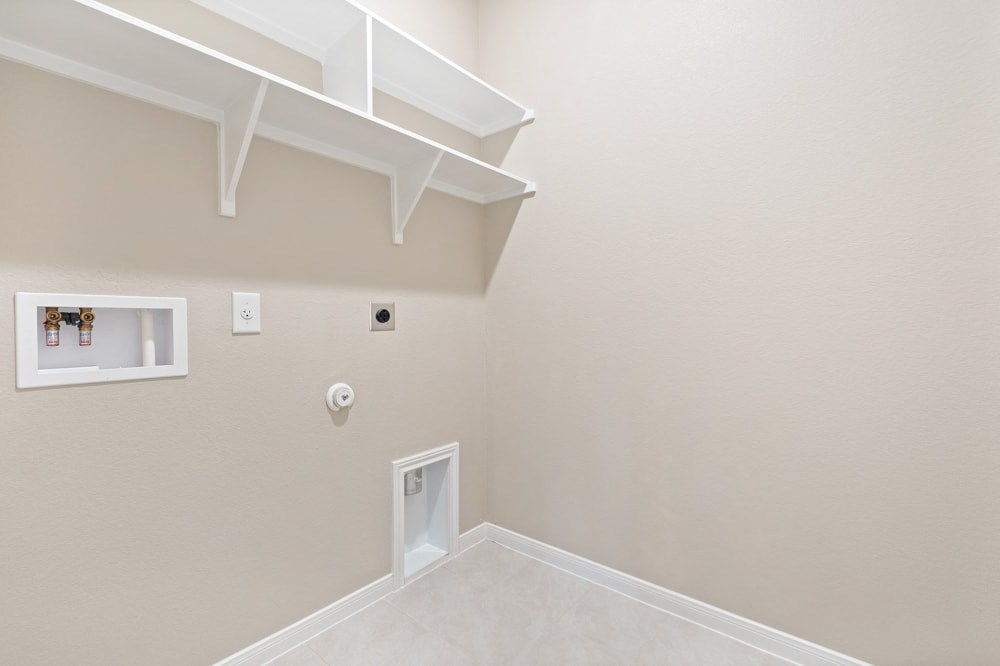 the basement of a house with a white wall and a white door