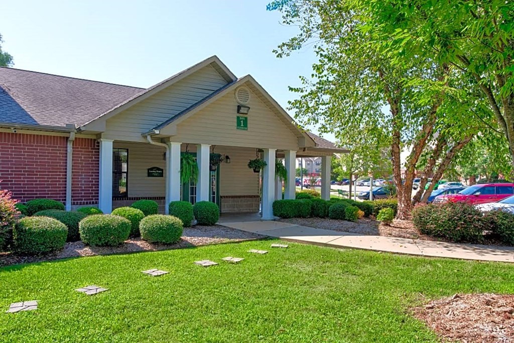 A small building with a green sign on the front.