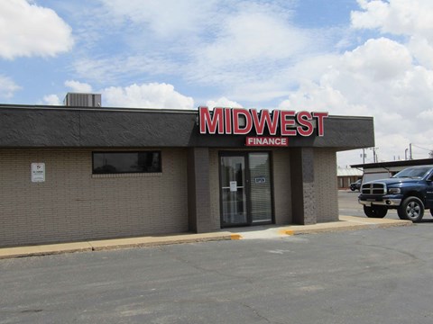 the front of a midwest finance building with a car parked in front