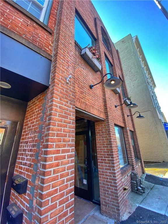 the front of a brick building with a glass door
