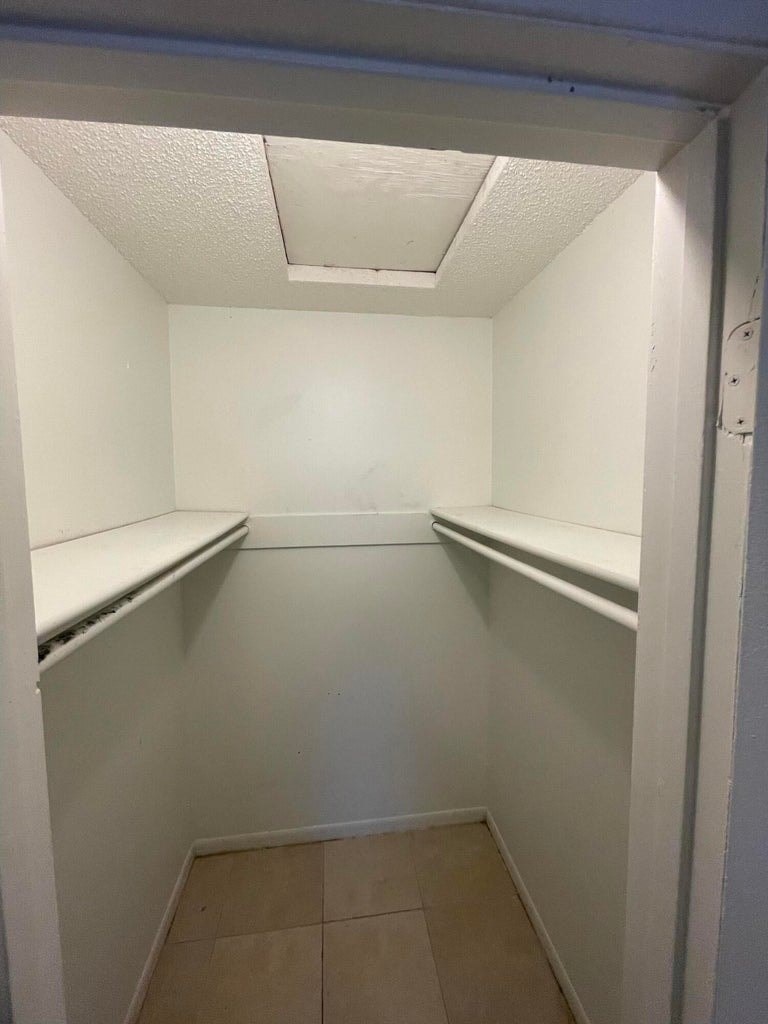 A small, empty room with a tiled floor and white walls.