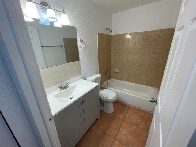 A bathroom with a sink, toilet, and bathtub.