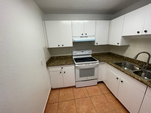 A kitchen with white cabinets and a granite countertop.