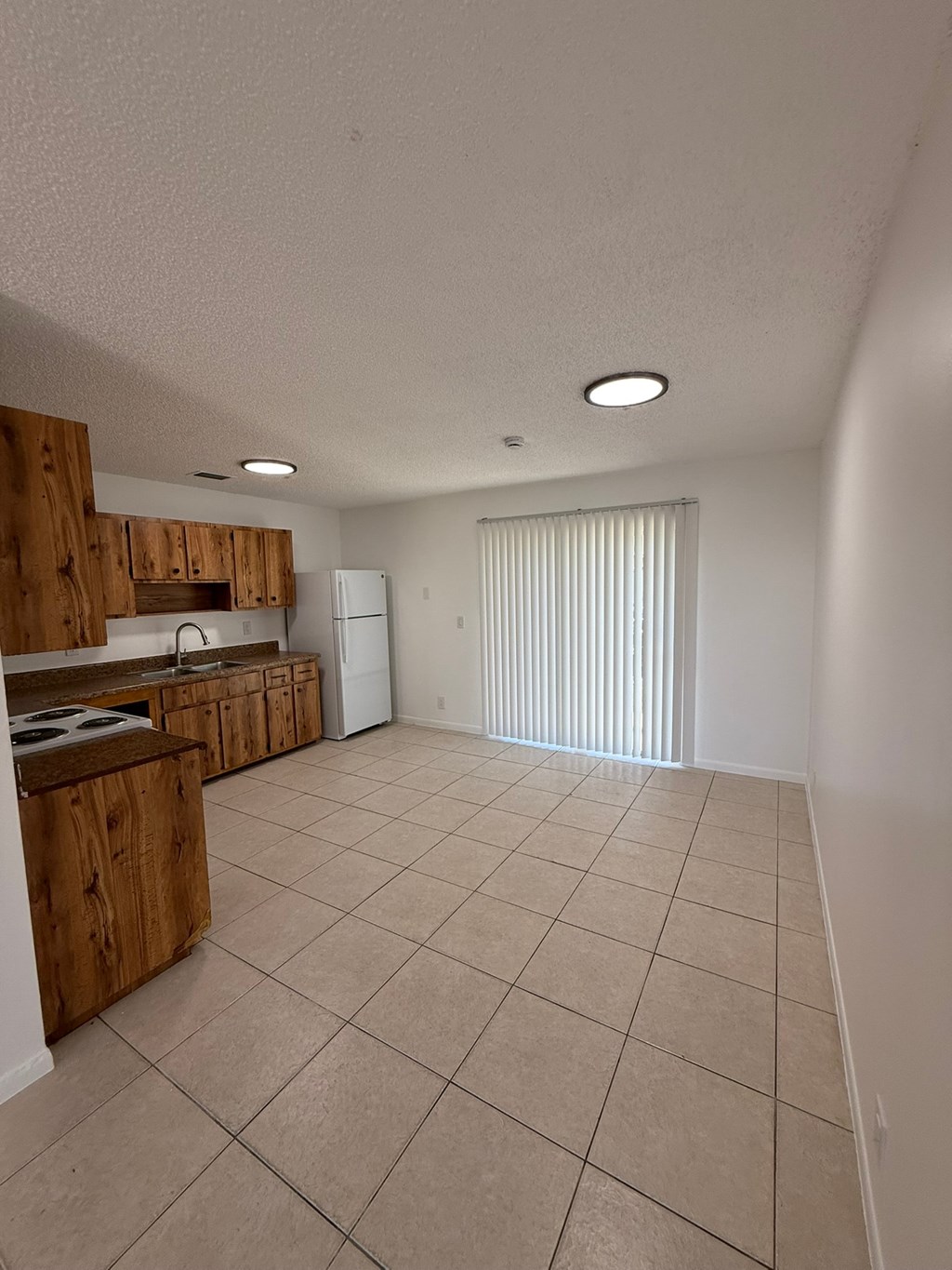 A kitchen with wooden cabinets and a countertop.