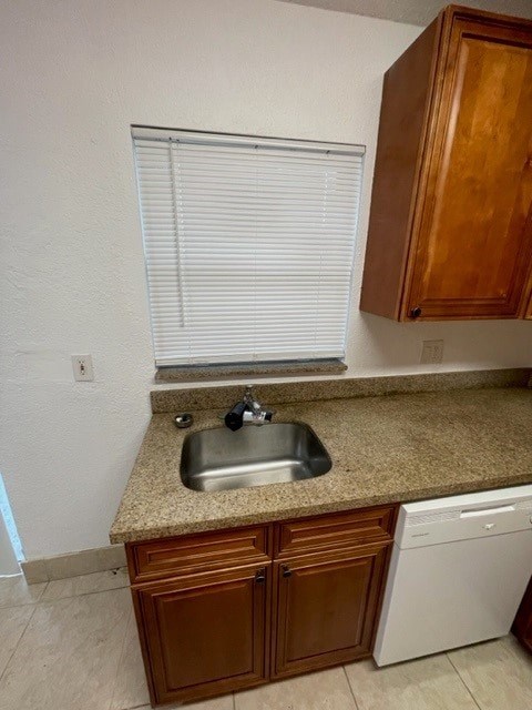 A kitchen with a sink and a dishwasher.
