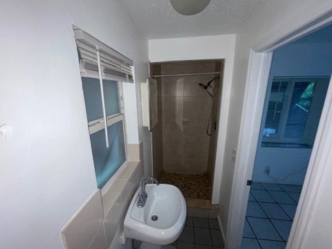 A bathroom with a sink, toilet and shower.