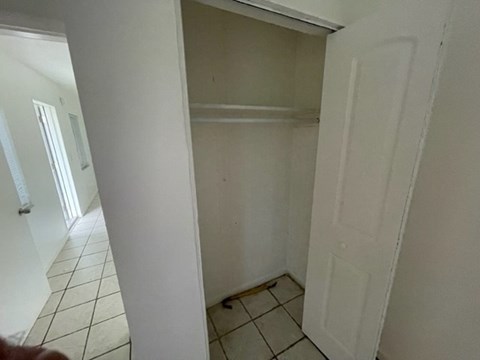 A white door is in a white room.