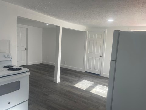 A kitchen with a stove and a refrigerator.