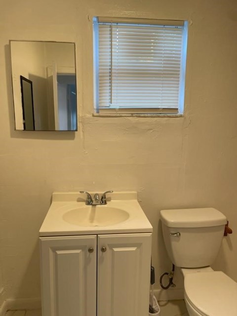 A white sink and toilet in a bathroom.