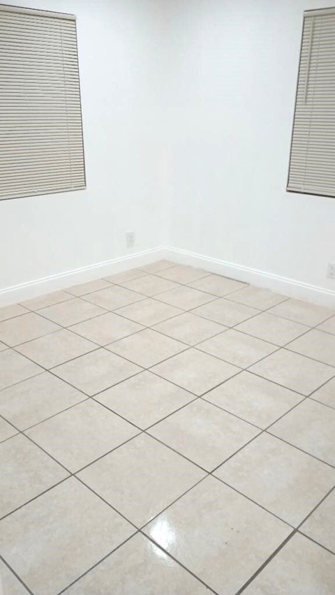 A room with white walls and a tiled floor.