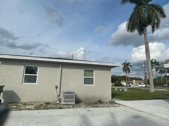 a small house with a palm tree in front of it