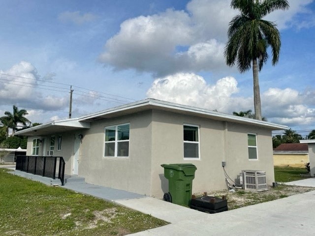 a white house with a palm tree in front of it