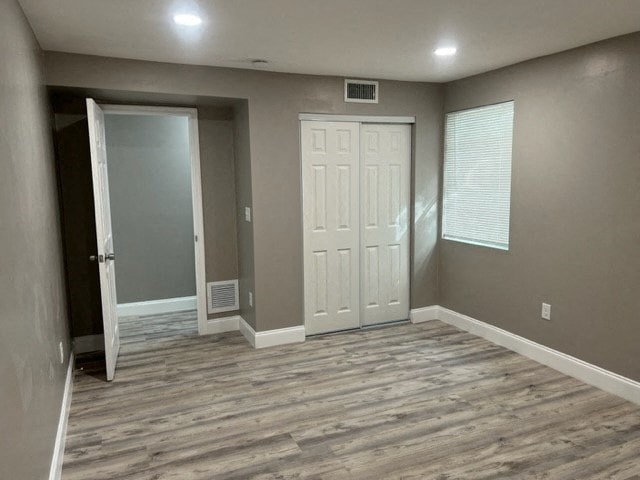 a empty room with a white door and a closet