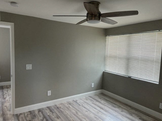 a living room with a ceiling fan and a window