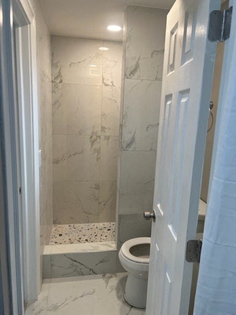 a small bathroom with a toilet and a shower