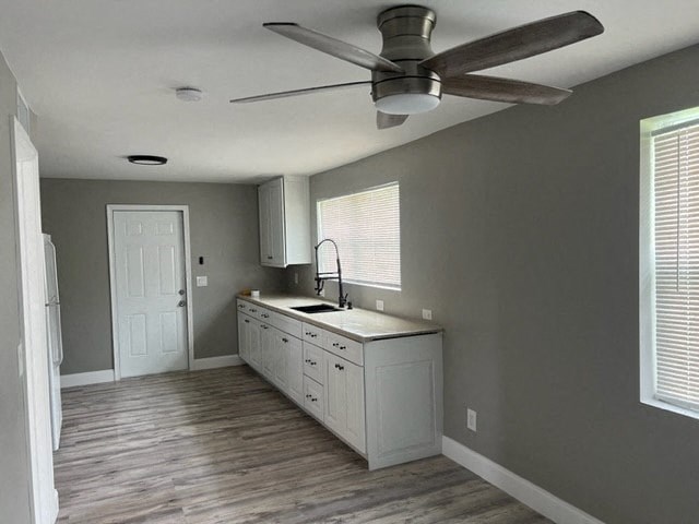 a kitchen with a ceiling fan and a sink