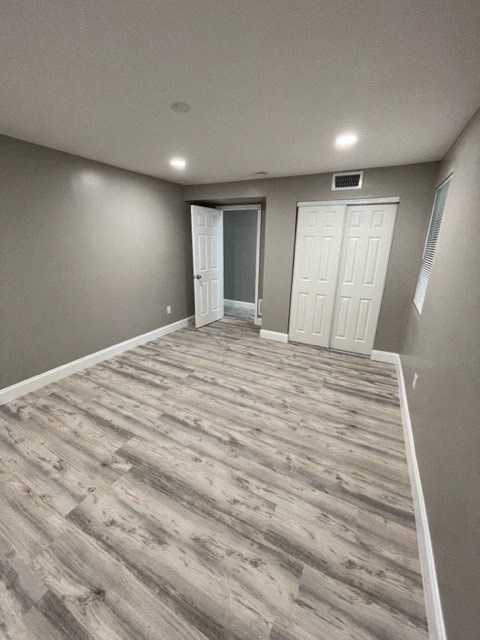 a empty room with wood floors and a white door