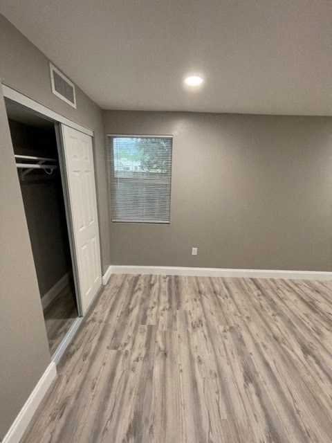 a empty room with wood floors and a closet