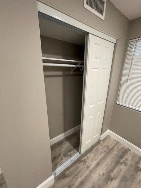 an empty closet in a room with a door