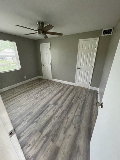 a empty room with a ceiling fan and a door