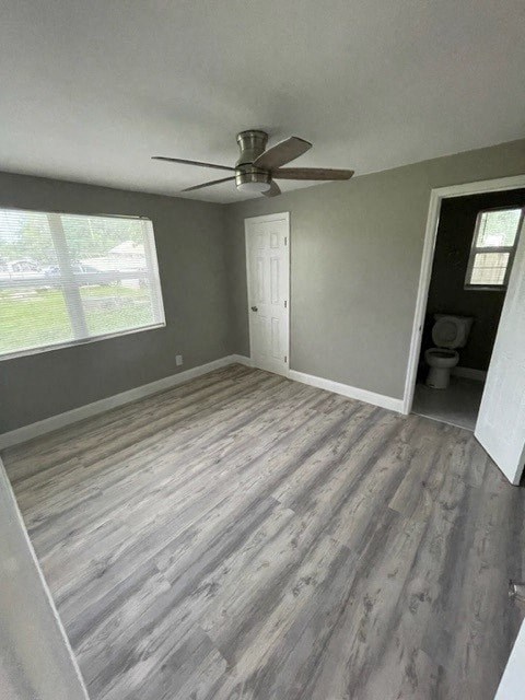 an empty living room with a ceiling fan