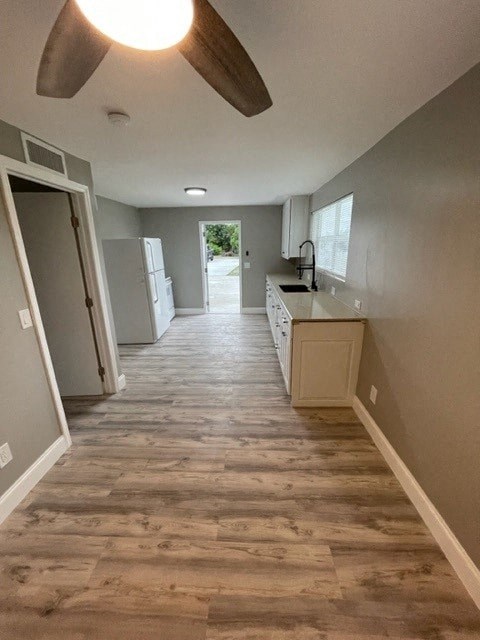 a empty kitchen with a wood floor