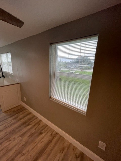 an empty room with a window and a sink