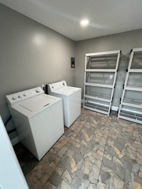 a room with two washing machines and a stack of ladders