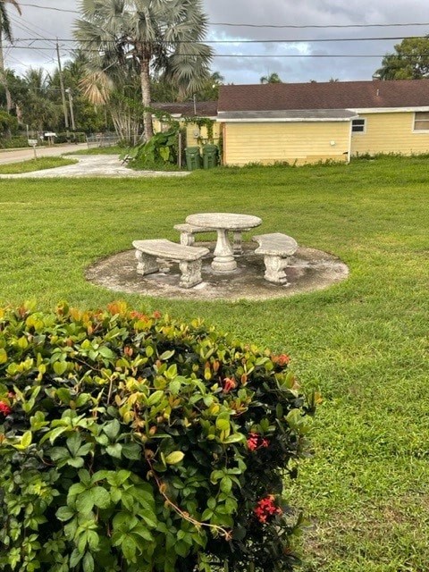 a stone picnic table and benches in a yard