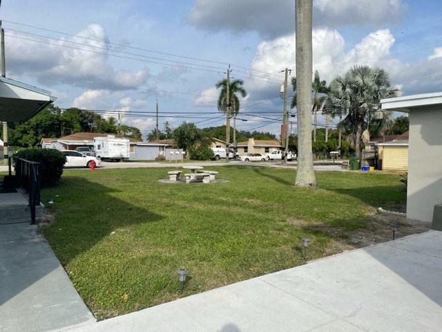 a yard with a picnic table in the grass