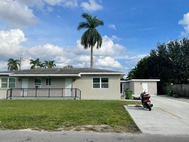 a motorcycle parked in front of a house with a palm tree