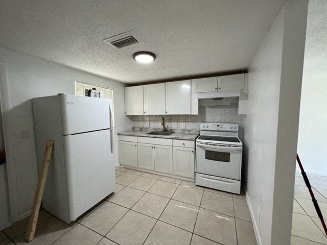 a kitchen with a stove and a refrigerator