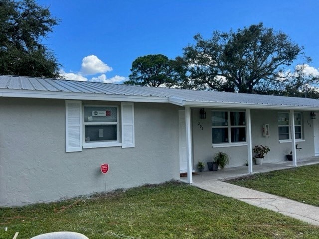 a white house with a yard and a red mailbox