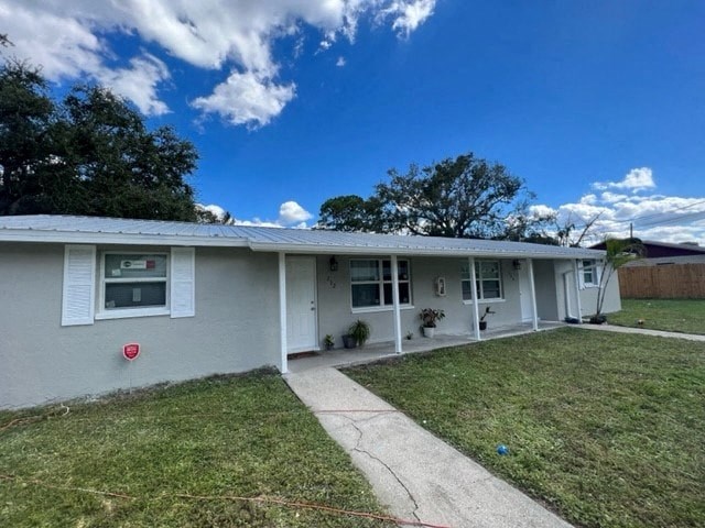 a white house with a yard and a sidewalk