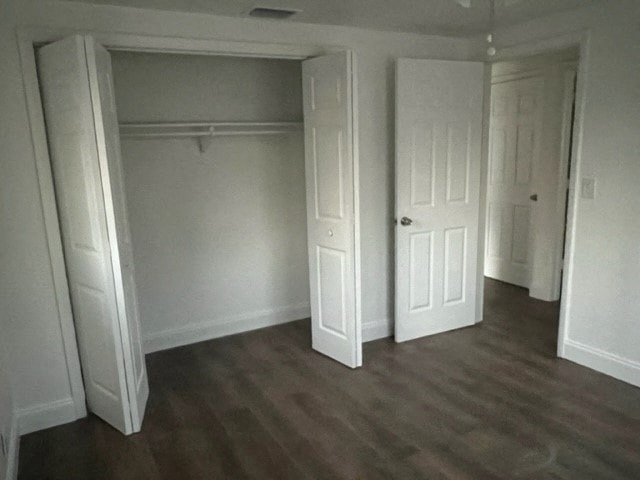an empty room with white walls and a wood floor