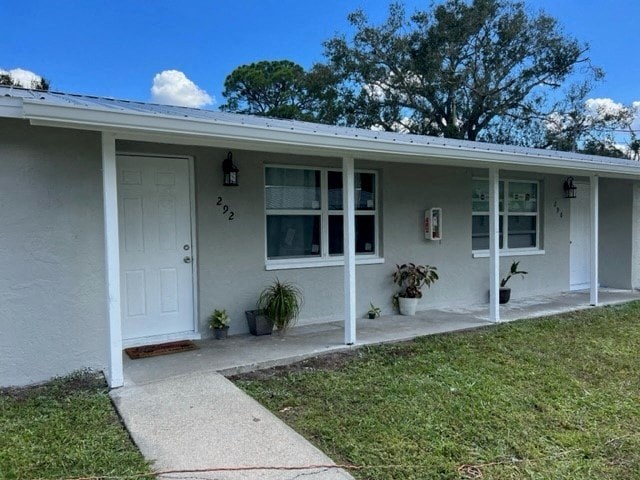 a white house with a white door and a porch