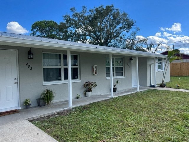 a white house with a lawn in front of it
