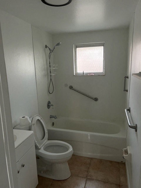 a bathroom with a toilet and a bath tub