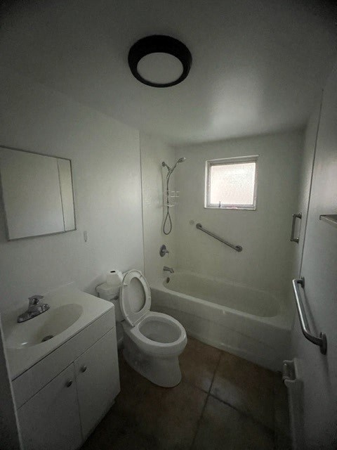 a bathroom with a toilet and a sink and a bath tub