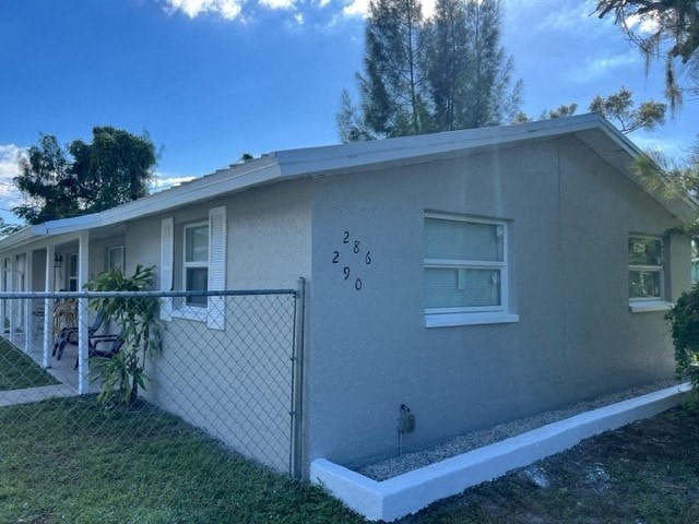 a white house with a fence in front of it